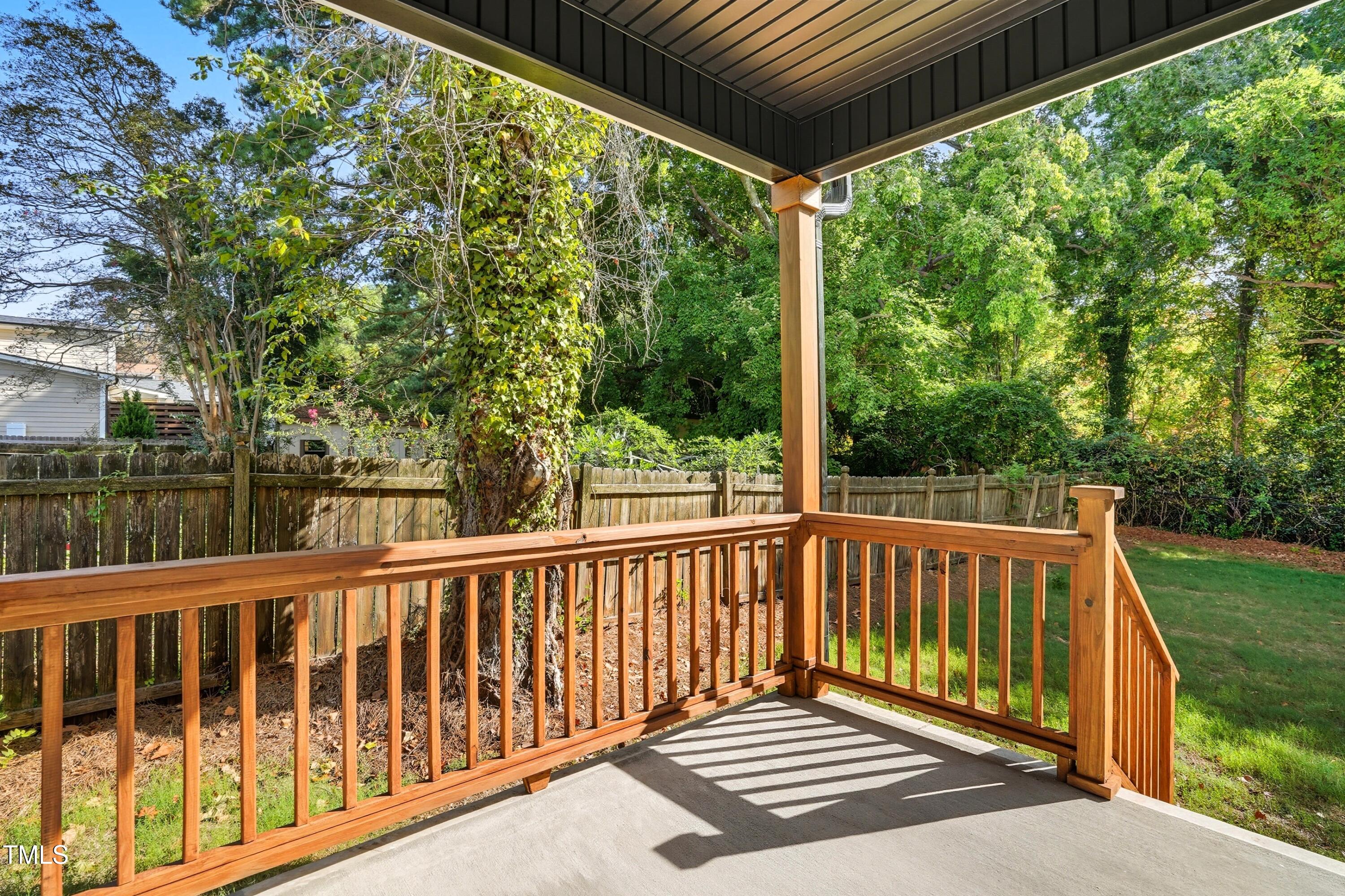 304 North King Charles Road, Unit 102 Raleigh, NC 27610 - Photo 30 of 30 a view of a wooden deck next to a yard