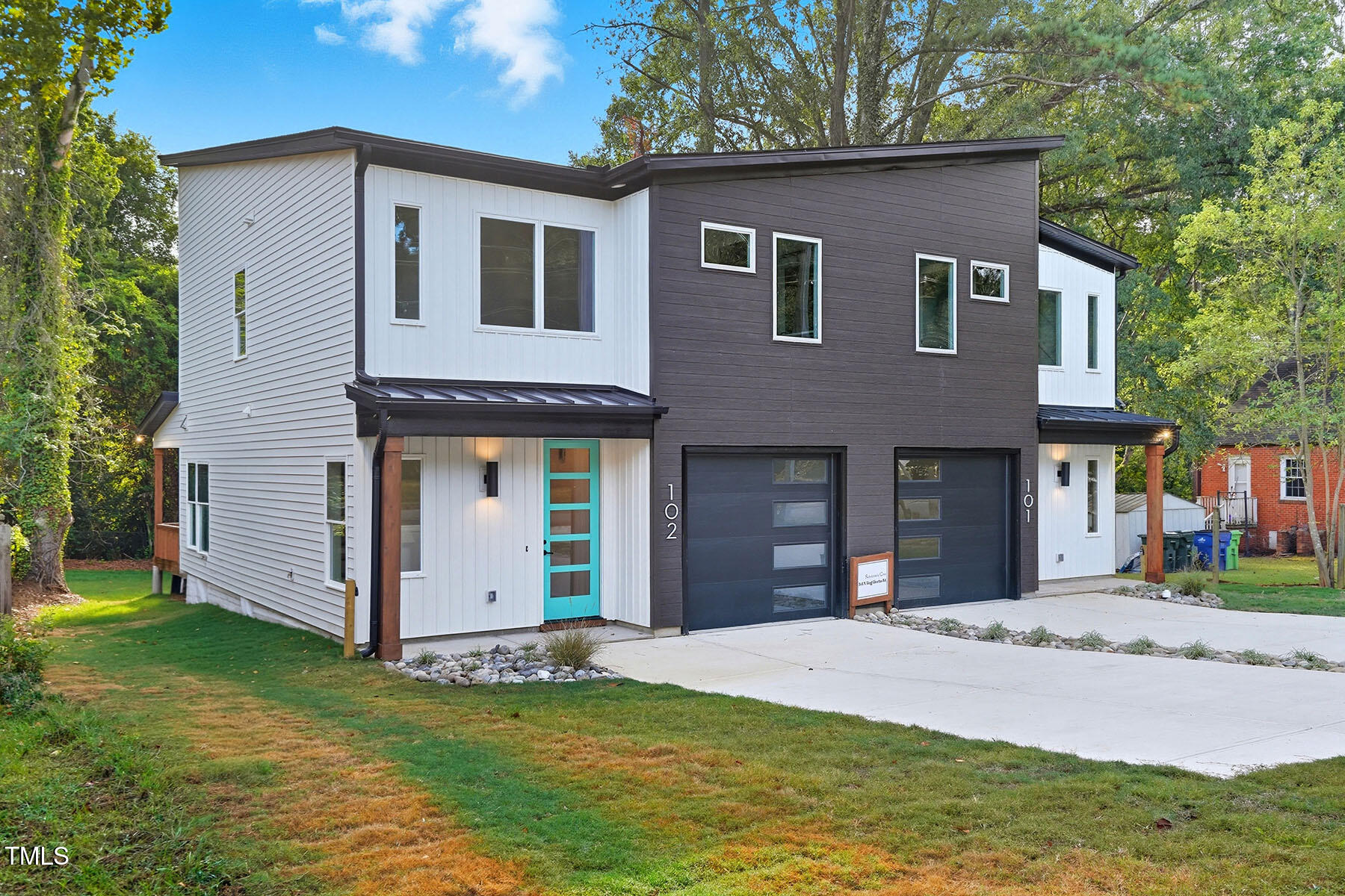 304 North King Charles Road, Unit 102 Raleigh, NC 27610 - Photo 3 of 30 a front view of a house with a yard and garage