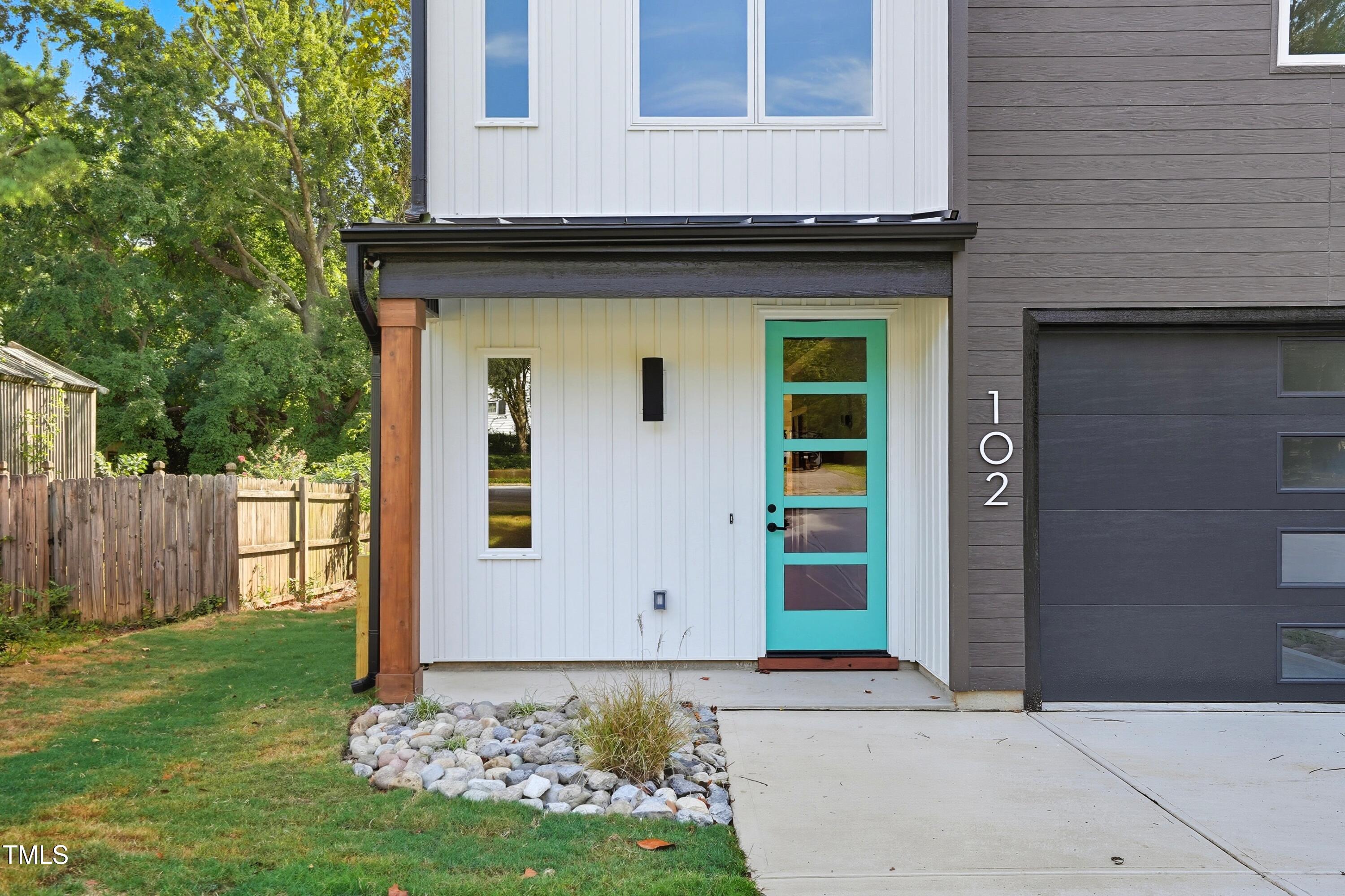 304 North King Charles Road, Unit 102 Raleigh, NC 27610 - Photo 4 of 30 a front view of a house with garden