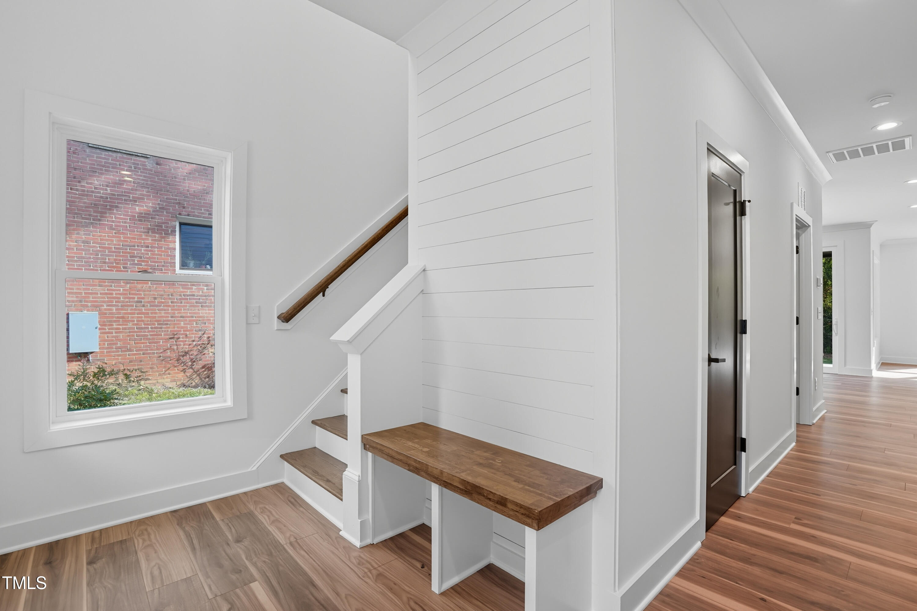 304 North King Charles Road, Unit 102 Raleigh, NC 27610 - Photo 5 of 30 a view of entryway with wooden floor and stairs