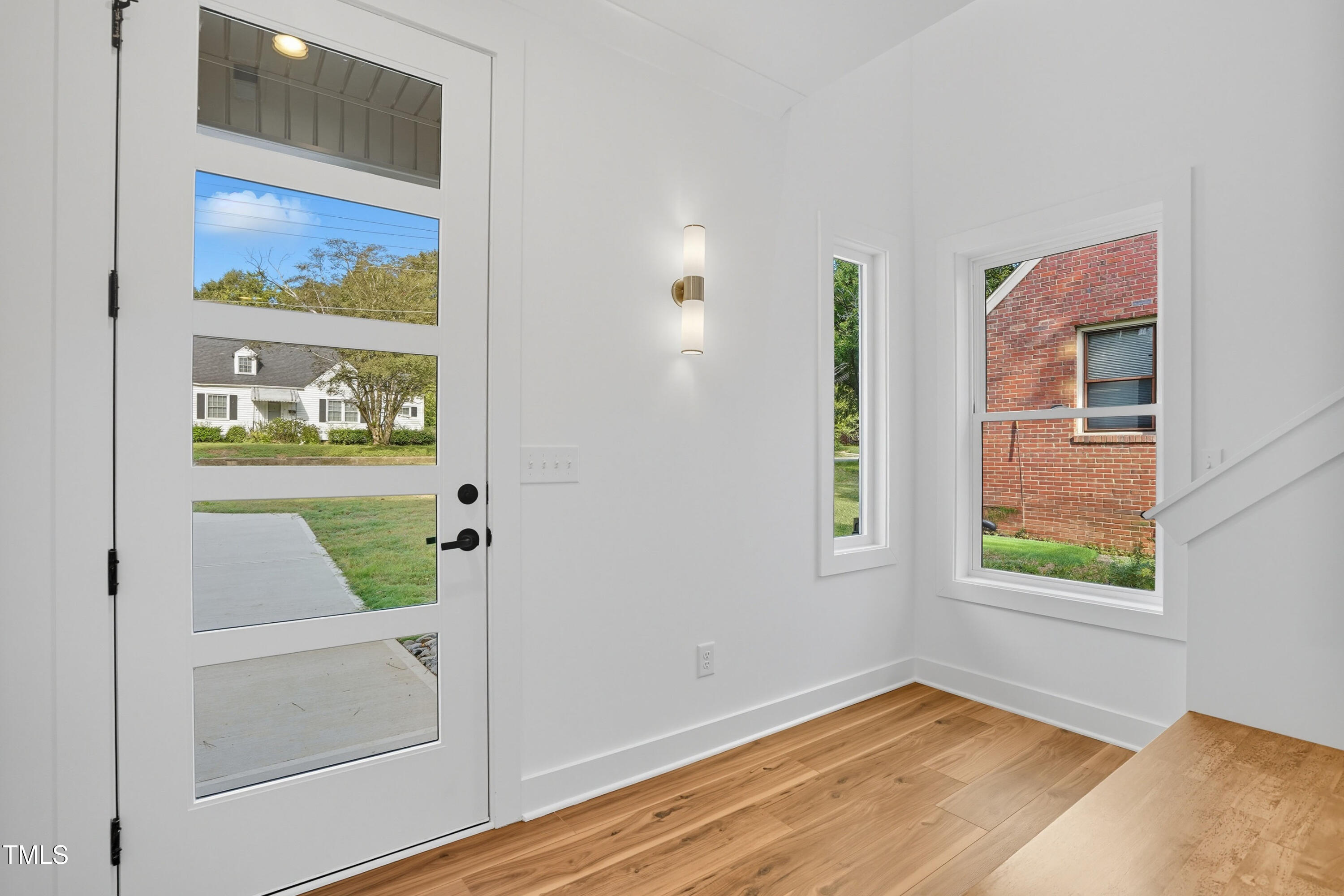 304 North King Charles Road, Unit 102 Raleigh, NC 27610 - Photo 6 of 30 a view of an entryway with wooden floor