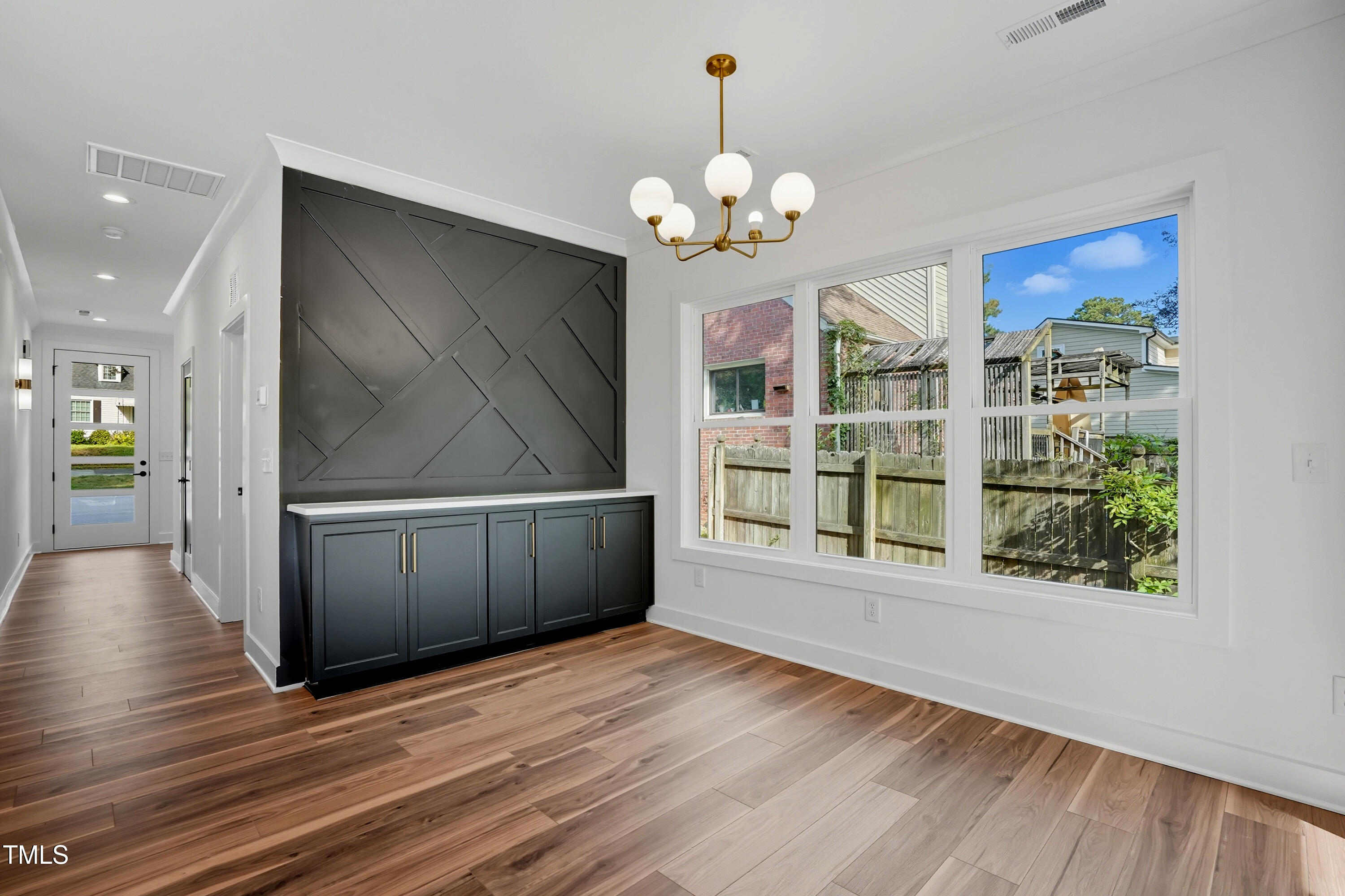 304 North King Charles Road, Unit 102 Raleigh, NC 27610 - Photo 9 of 30 a view of a room with wooden floor and chandelier