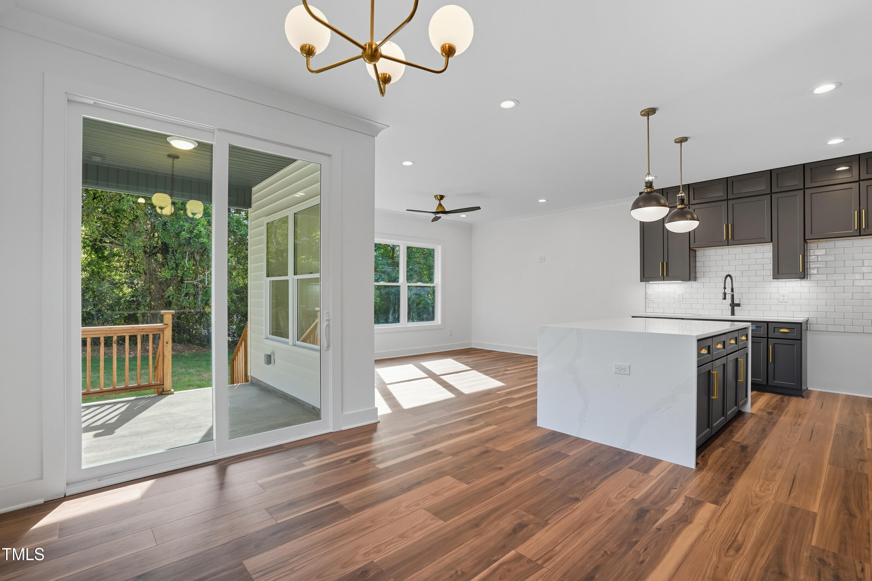 304 North King Charles Road, Unit 102 Raleigh, NC 27610 - Photo 10 of 30 a kitchen with a wooden floor and white appliances
