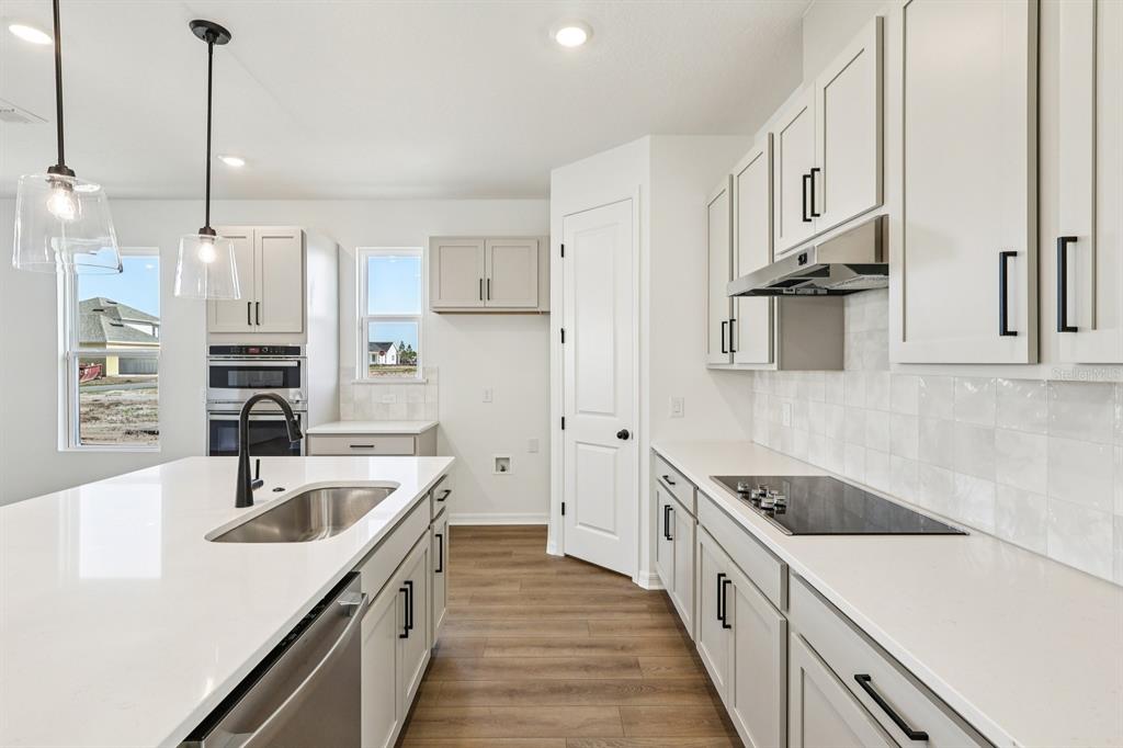 6673 Wake Street St. Cloud, FL 34771 - Photo 11 of 44 a kitchen with stainless steel appliances granite countertop a sink and a refrigerator