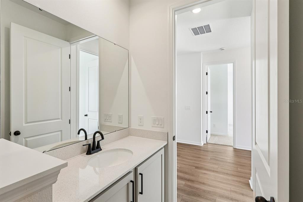 6673 Wake Street St. Cloud, FL 34771 - Photo 19 of 44 a bathroom with a sink and a mirror