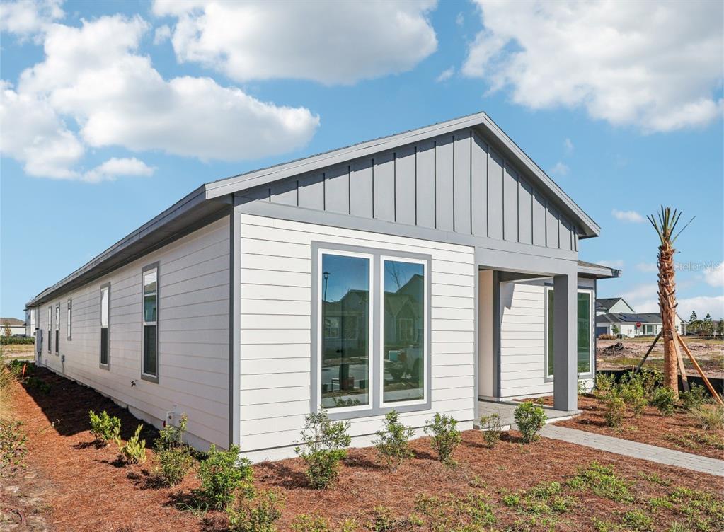 6673 Wake Street St. Cloud, FL 34771 - Photo 2 of 44 a view of a house with backyard and sitting area