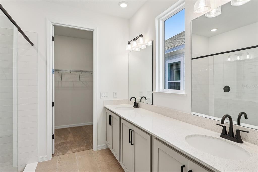 6673 Wake Street St. Cloud, FL 34771 - Photo 26 of 44 a bathroom with double sink and a mirror