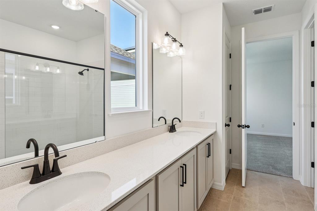 6673 Wake Street St. Cloud, FL 34771 - Photo 28 of 44 a bathroom with a sink and a mirror