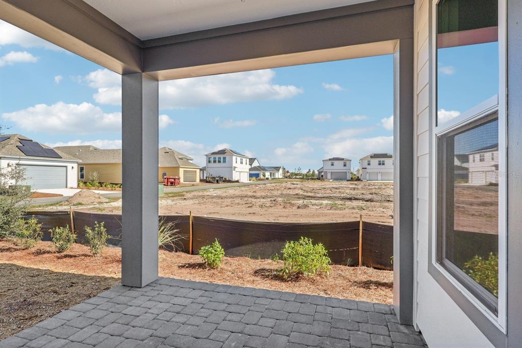 6673 Wake Street St. Cloud, FL 34771 - Photo 31 of 44 a view of a porch with a dining table and chairs