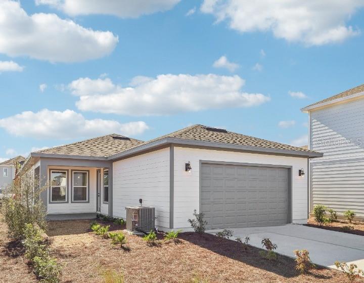 6673 Wake Street St. Cloud, FL 34771 - Photo 36 of 44 a front view of a house with a yard