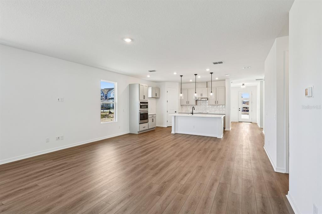 6673 Wake Street St. Cloud, FL 34771 - Photo 7 of 44 a view of a kitchen with wooden floor and a sink