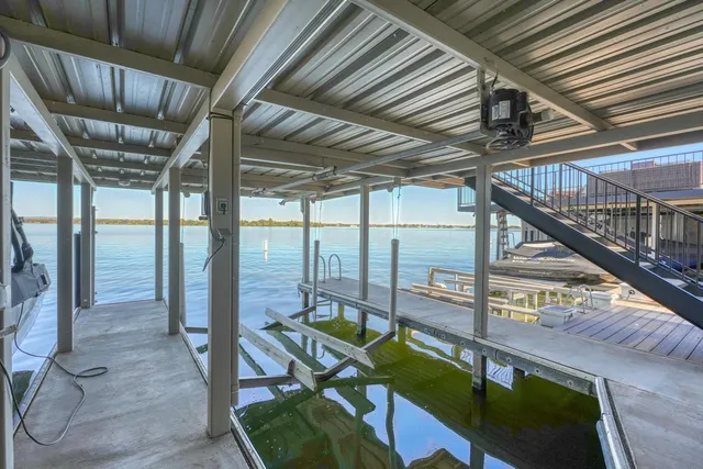 a view of roof deck with table and chairs