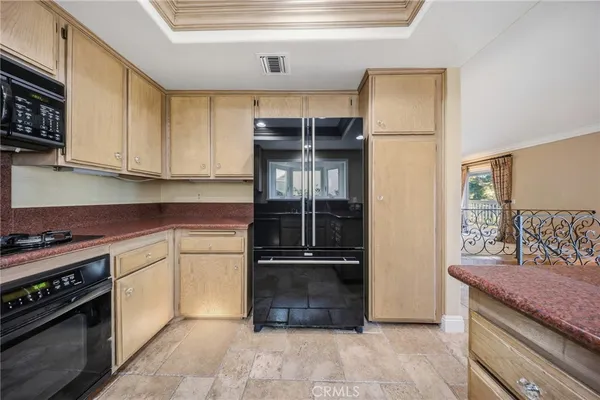 a kitchen with granite countertop a refrigerator and a stove