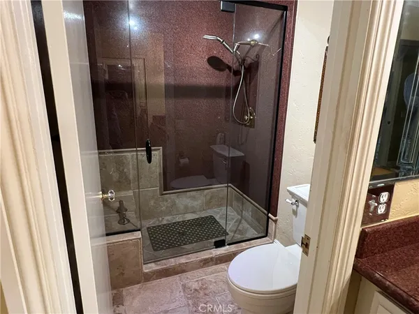 a bathroom with a toilet and a shower