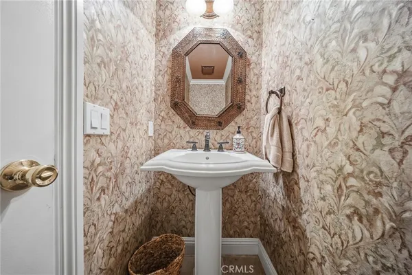 a bathroom with a sink toilet and mirror