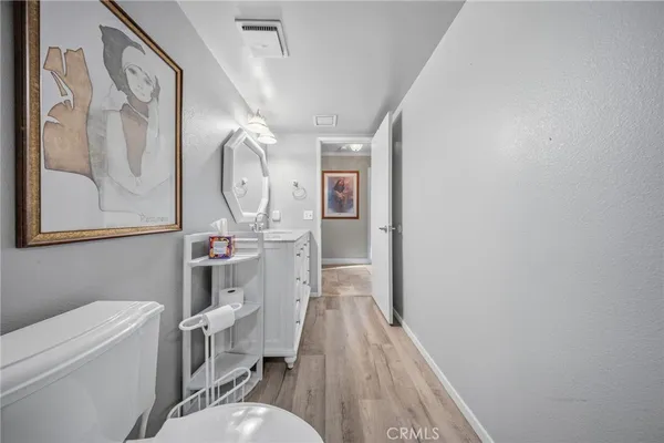 a very nice looking room with a wooden floor and a mirror