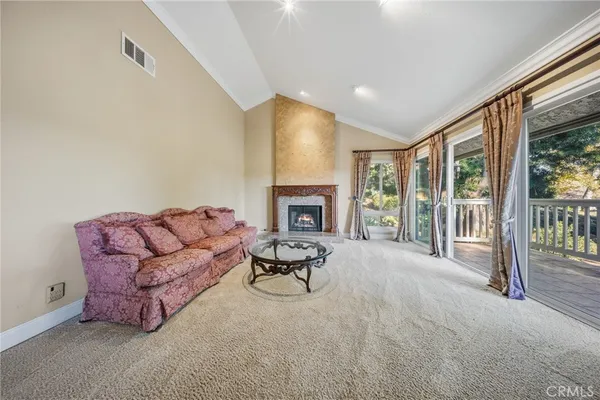 a living room with furniture fireplace and a large window