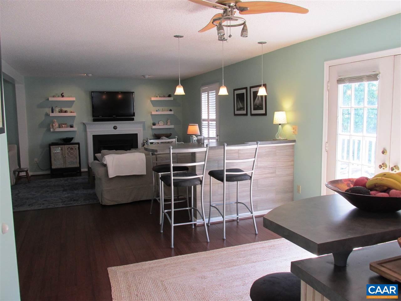 2704 Huntington Road Charlottesville, VA 22901 - Photo 12 of 42 a living room with furniture a flat screen tv and kitchen view