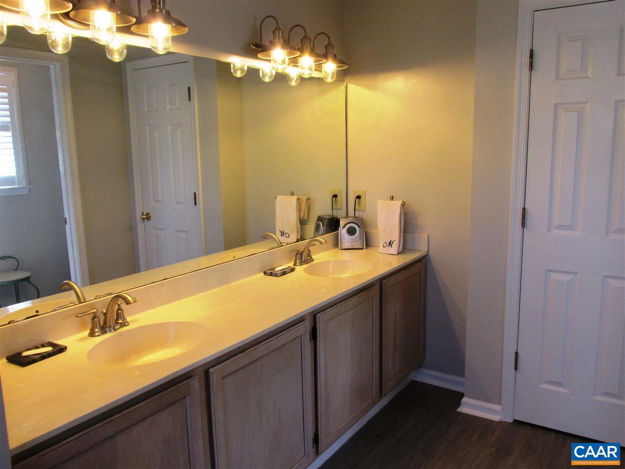 2704 Huntington Road Charlottesville, VA 22901 - Photo 21 of 42 a bathroom with a double vanity sink and a mirror
