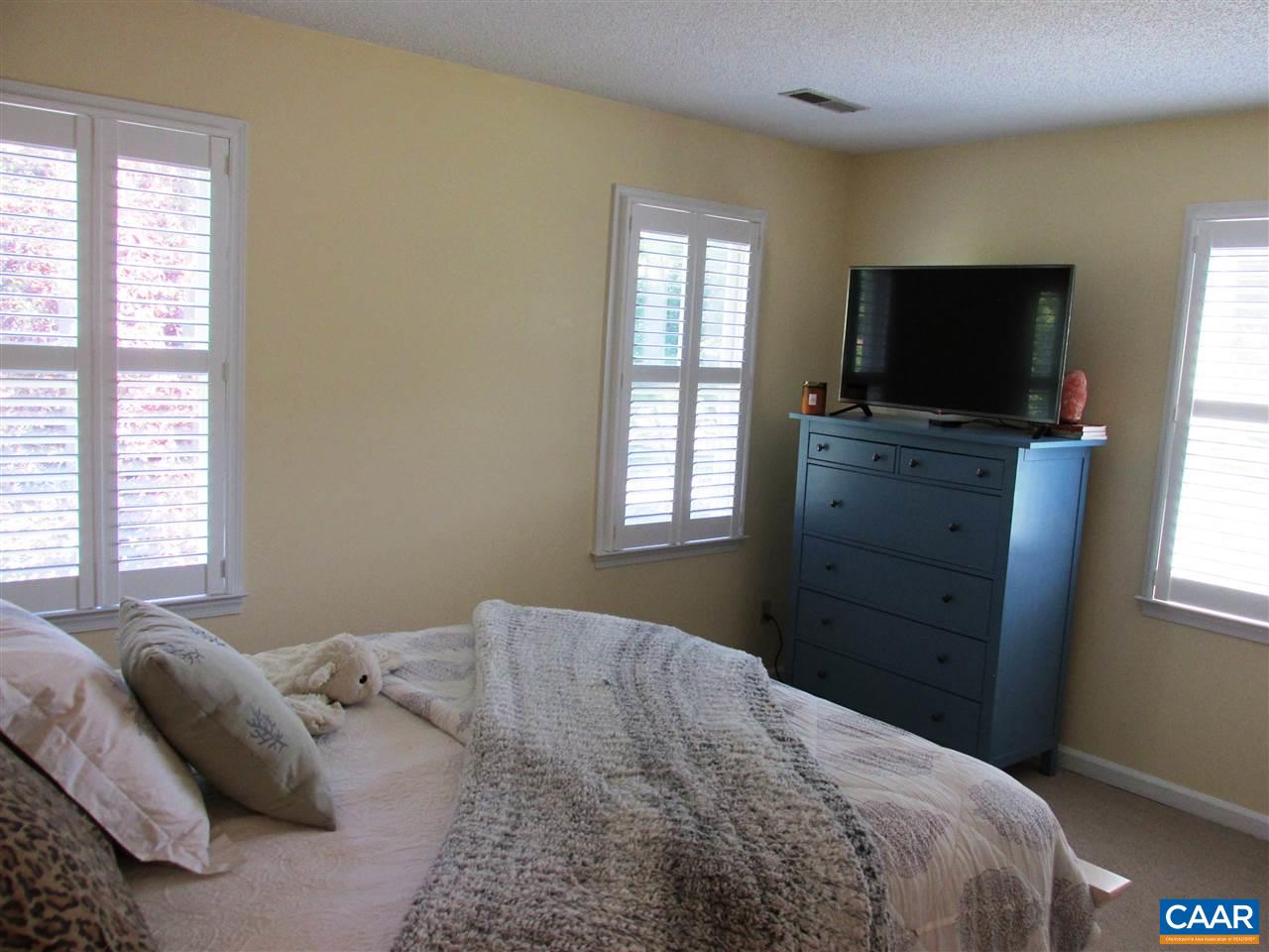 2704 Huntington Road Charlottesville, VA 22901 - Photo 26 of 42 a bedroom with a bed and flat screen tv