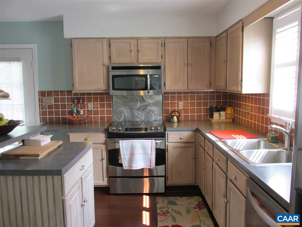 2704 Huntington Road Charlottesville, VA 22901 - Photo 6 of 42 a kitchen with stainless steel appliances granite countertop a sink stove and refrigerator