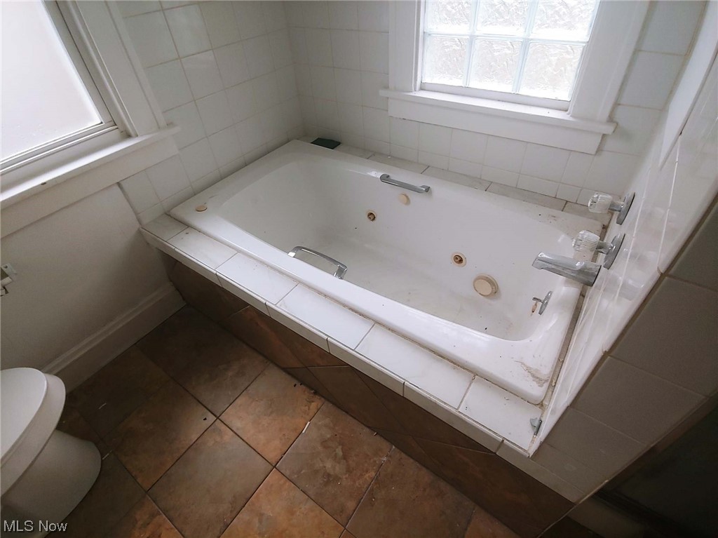 1464 Sherbrook Road Cleveland, OH 44121 - Photo 11 of 15 Bathroom featuring tile floors, tiled bath, and tile walls