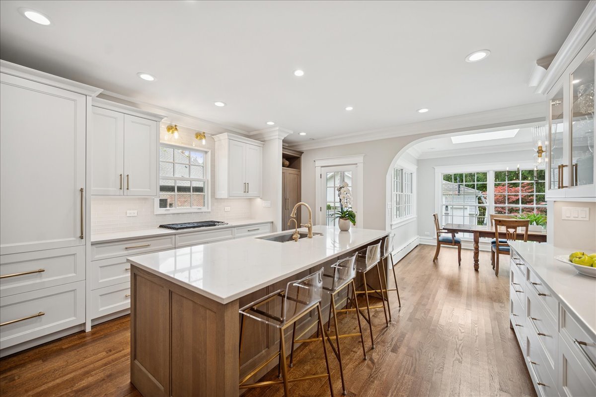 755 Lincoln Avenue Winnetka, IL 60093 - Photo 12 of 52 a kitchen with stainless steel appliances granite countertop a table chairs stove and white cabinets