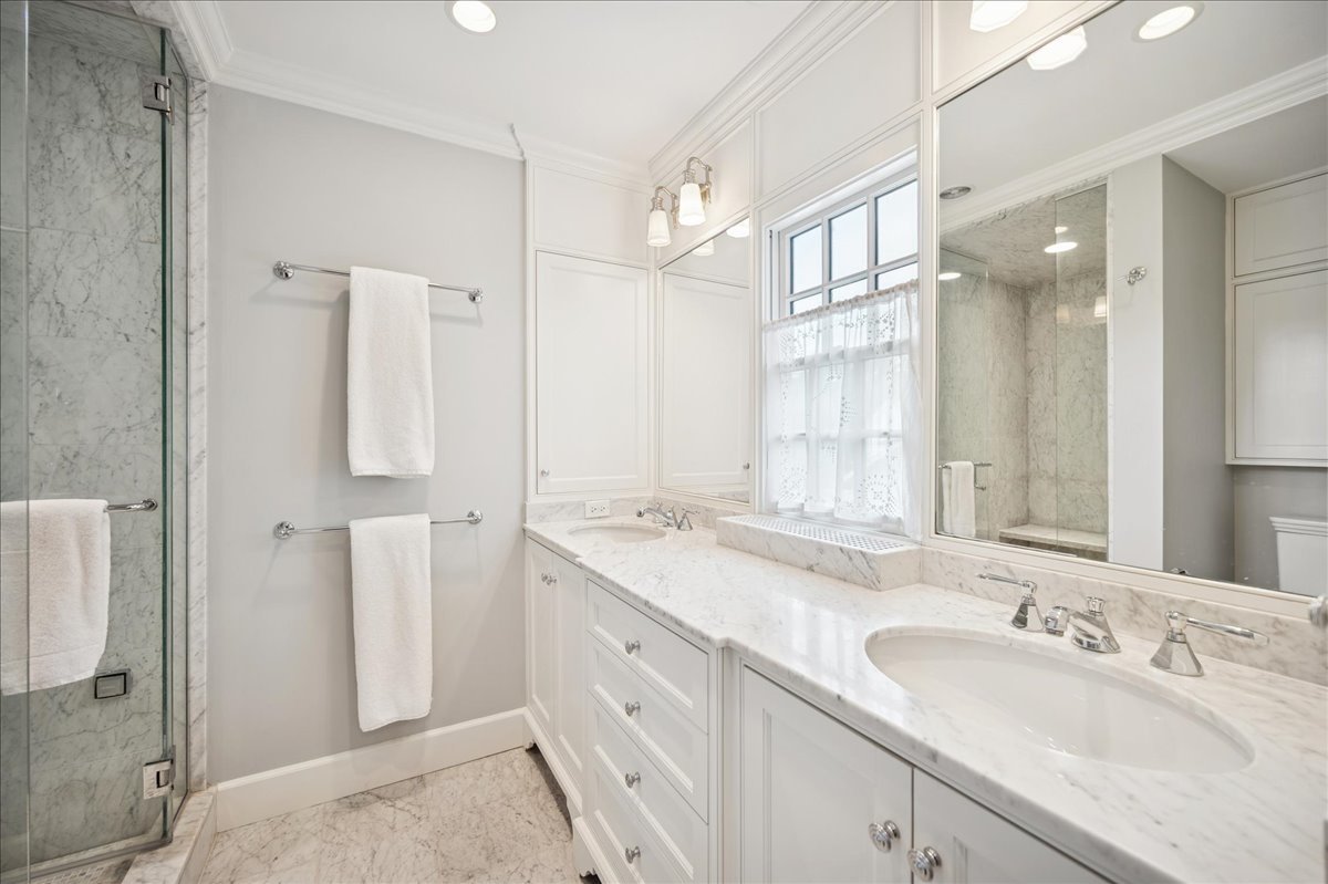 755 Lincoln Avenue Winnetka, IL 60093 - Photo 32 of 52 a bathroom with a granite countertop sink and a mirror