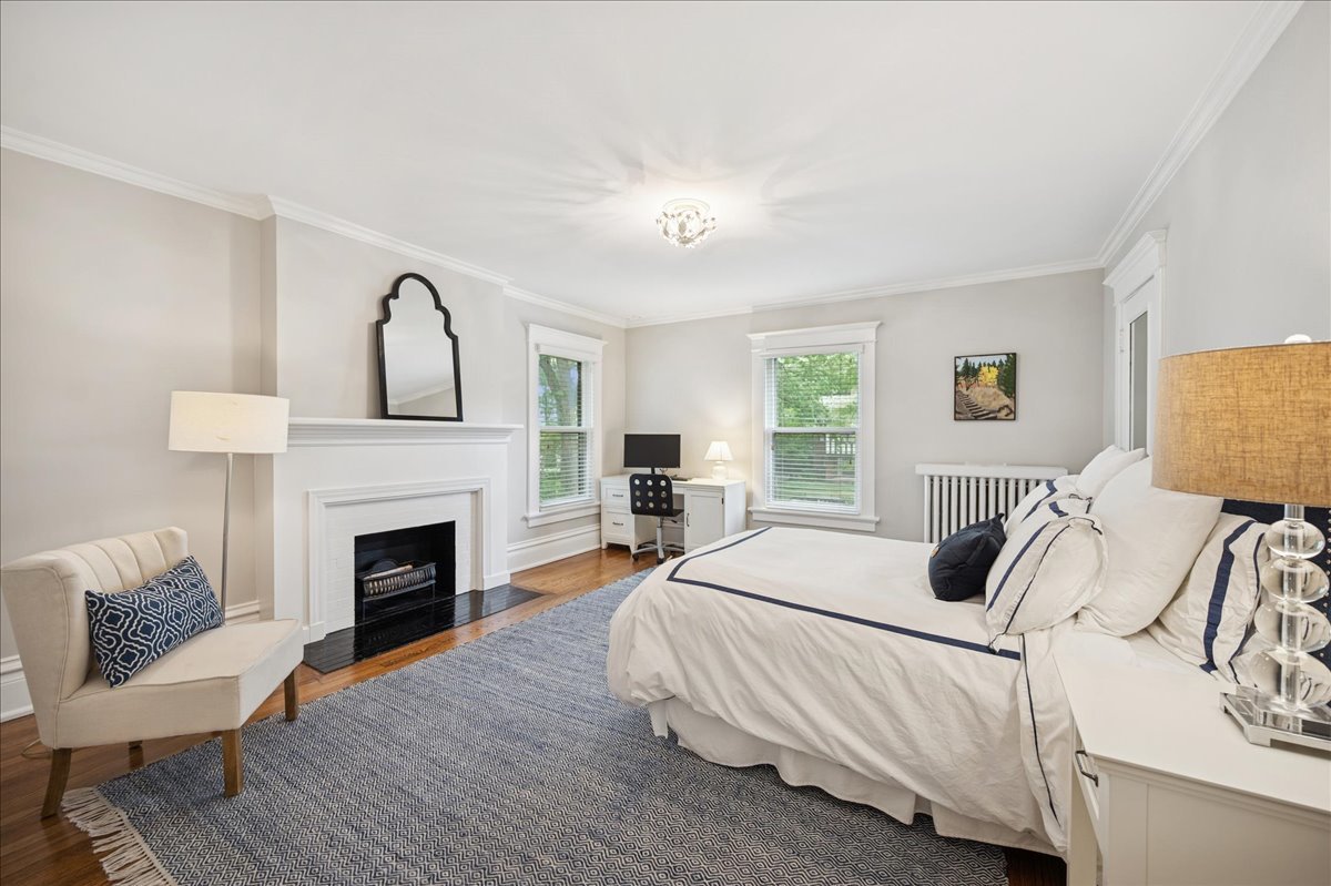 755 Lincoln Avenue Winnetka, IL 60093 - Photo 34 of 52 a bedroom with a bed and a fireplace