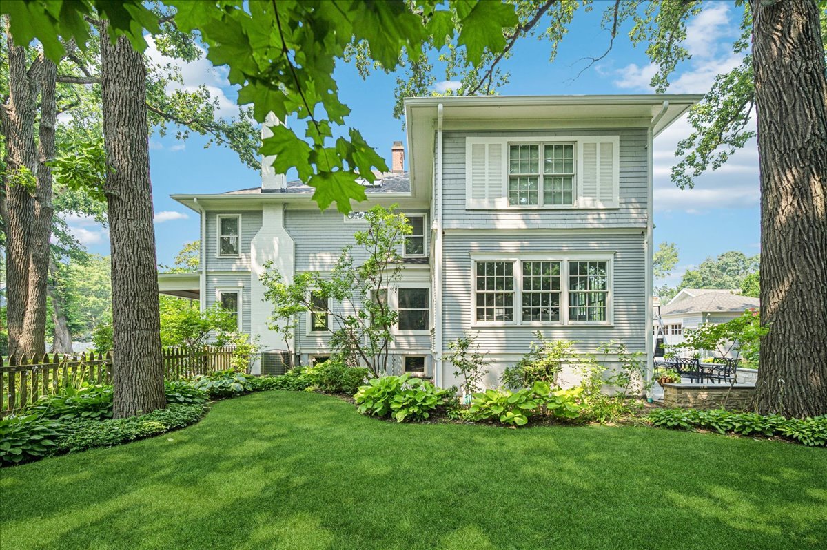 755 Lincoln Avenue Winnetka, IL 60093 - Photo 44 of 52 a view of a house with brick walls and a yard with plants