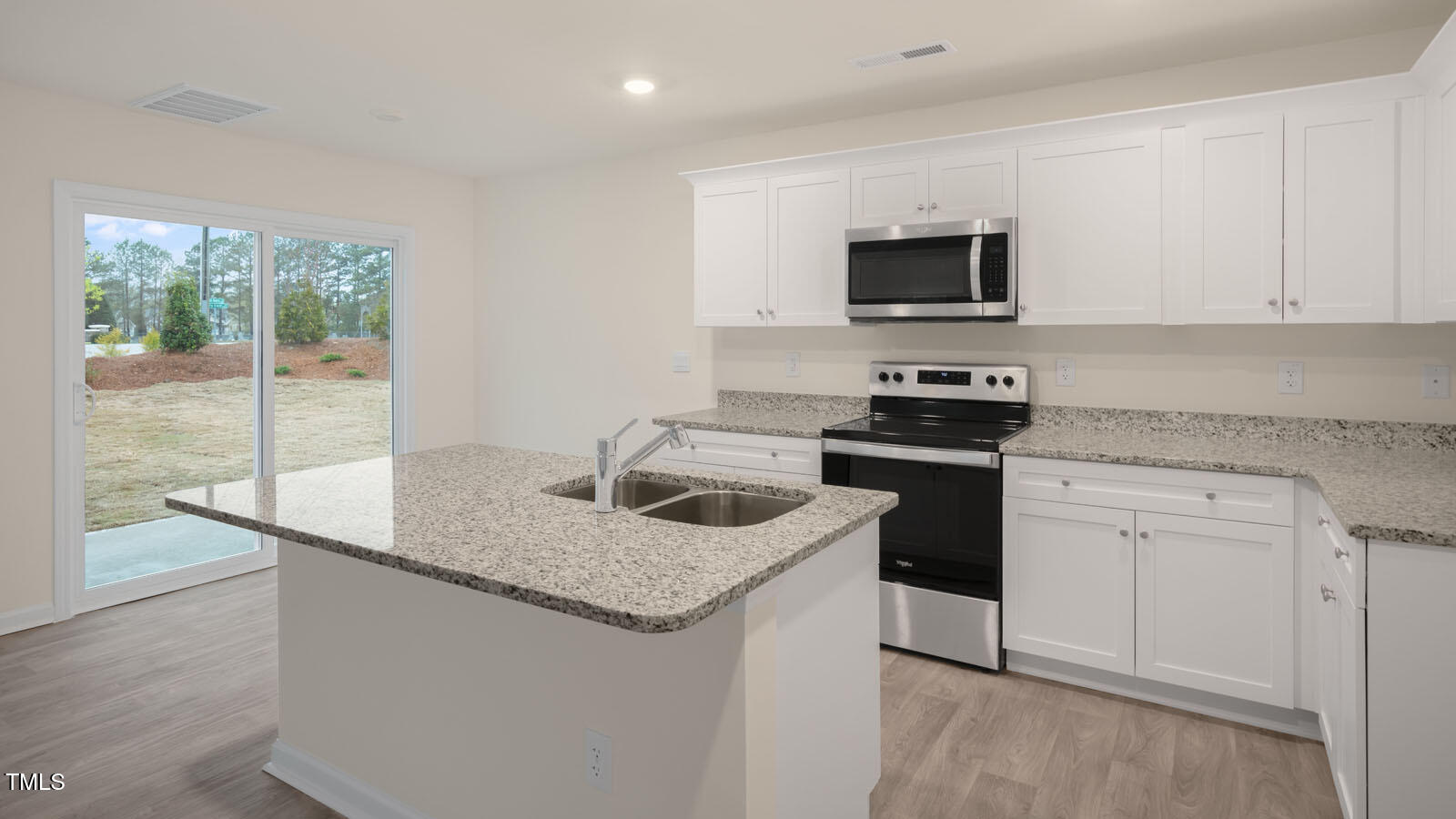 6025 Sodium Street Raleigh, NC 27610 - Photo 16 of 24 a kitchen with granite countertop a sink stove and cabinets