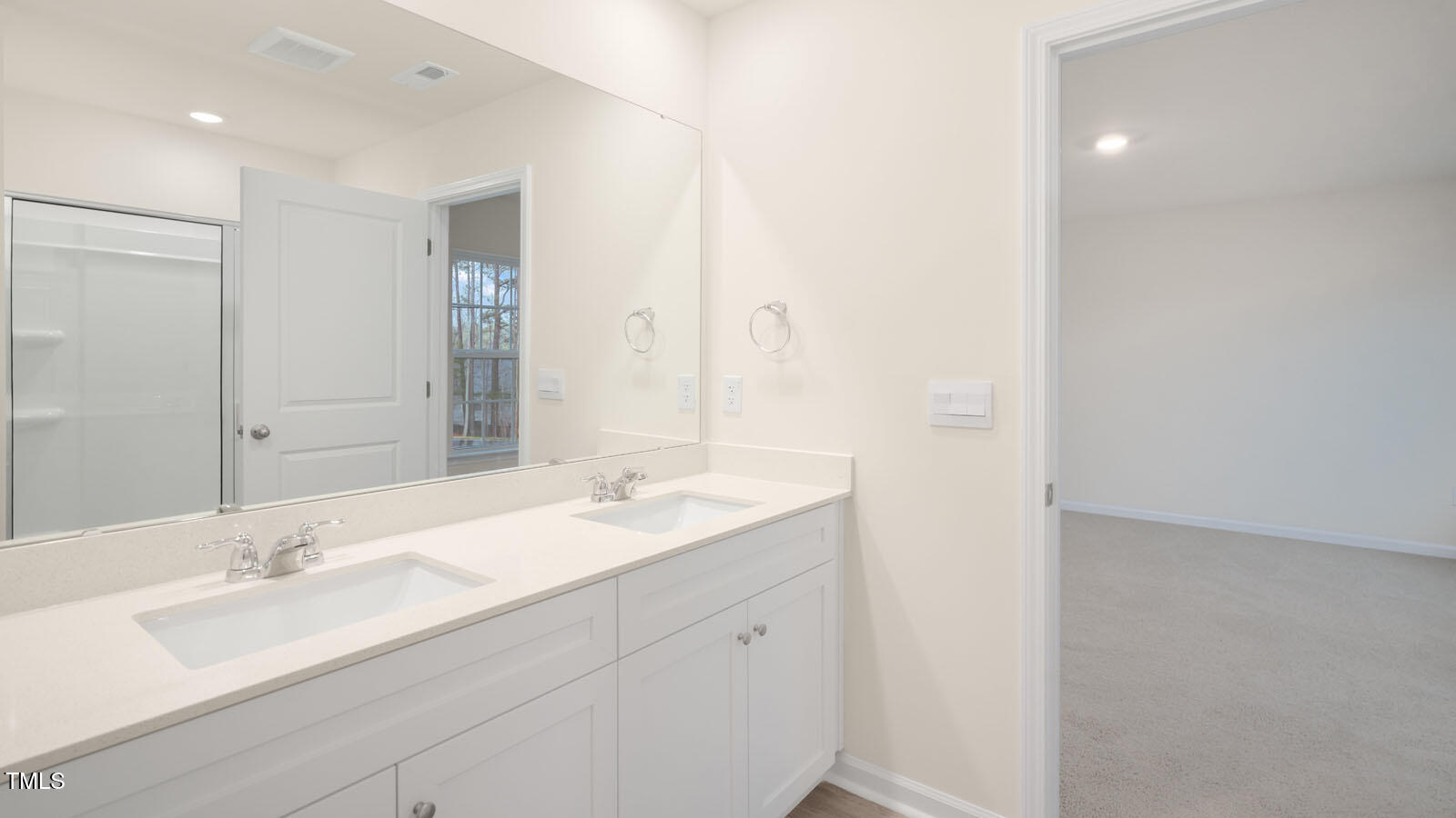 6025 Sodium Street Raleigh, NC 27610 - Photo 20 of 24 a bathroom with a double vanity sink and mirror