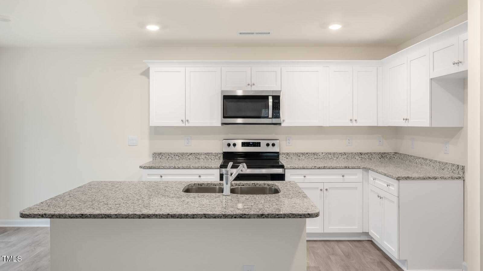 6025 Sodium Street Raleigh, NC 27610 - Photo 5 of 24 a kitchen with granite countertop a sink and a stove top oven