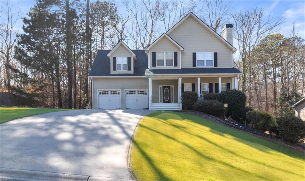a view of house with yard and outdoor seating