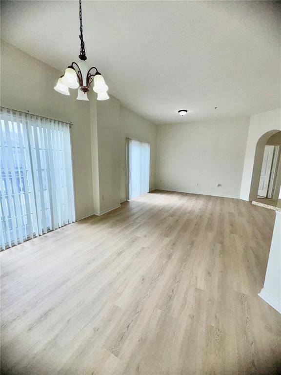 6404 South Goldenrod Road, Unit 2A Orlando, FL 32822 - Photo 35 of 40 a view of a livingroom with a chandelier fan and windows