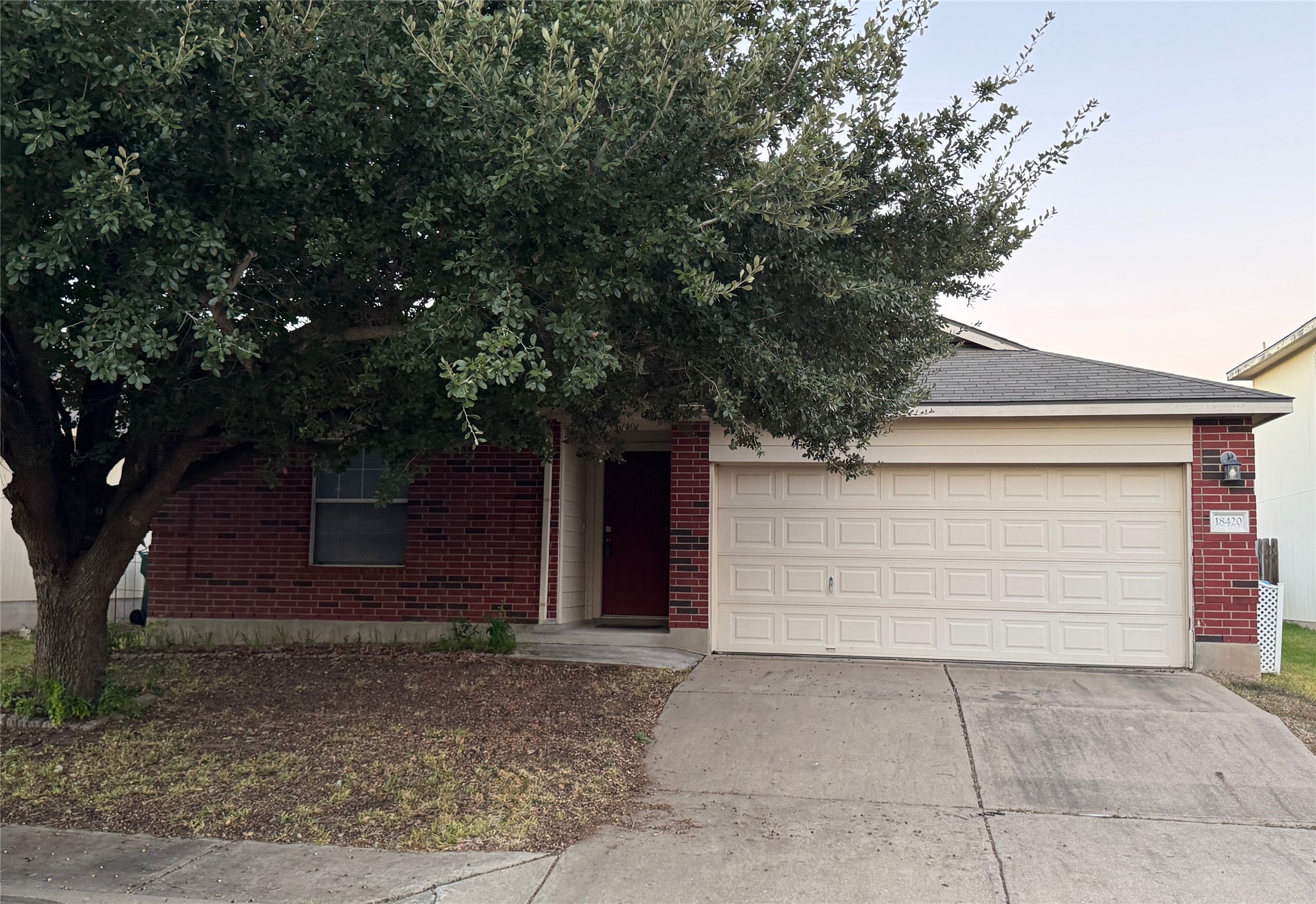 18420 Wind Tree Lane Elgin, TX 78621 - Photo 2 of 15 a small white house with a outdoor space