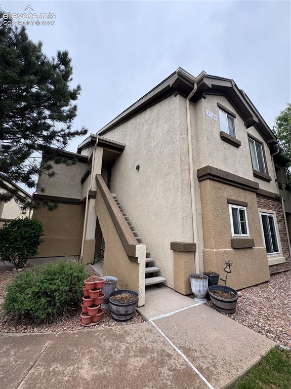 3748 Riviera Grove, Unit 203 Colorado Springs, CO 80922 - Photo 2 of 23 a view of a house with a yard