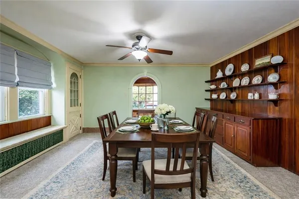 a dining room with furniture a rug and a window