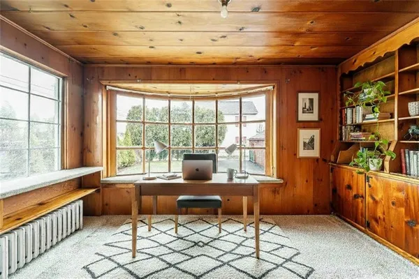 a living room with furniture and large windows