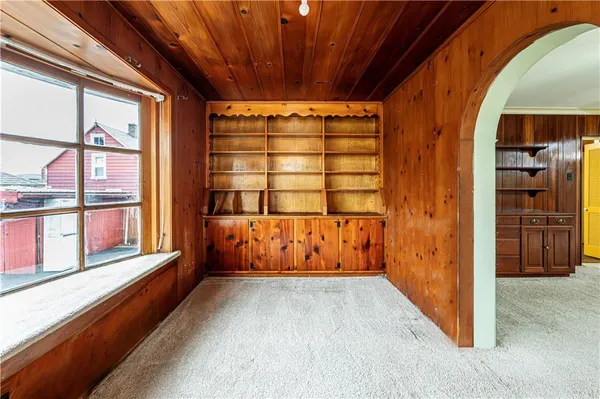 a view of a room with wooden floor and windows