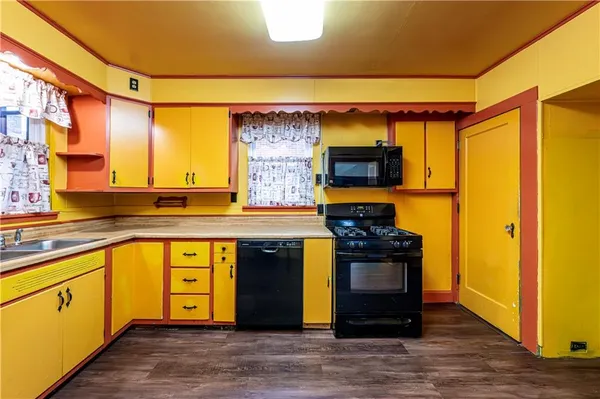 a kitchen with stainless steel appliances granite countertop a stove and a refrigerator