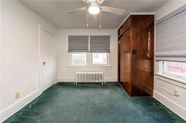 an empty room with windows and closet