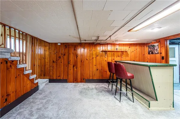 a view of a room with furniture and a rug