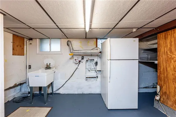 a hallway with a table and a refrigerator