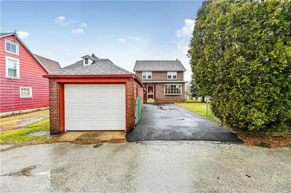 a view of a house with a yard and garage