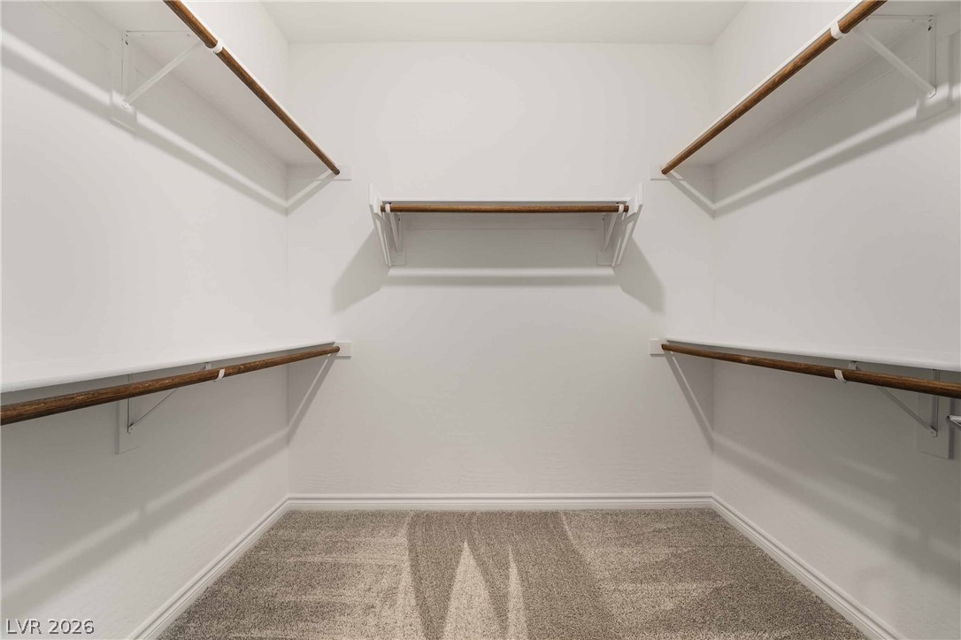 2555 Hampton Road, Unit 10202 Henderson, NV 89052 - Photo 29 of 35 Ample built-in shelving and soft carpeting define this functional walk-in closet space.