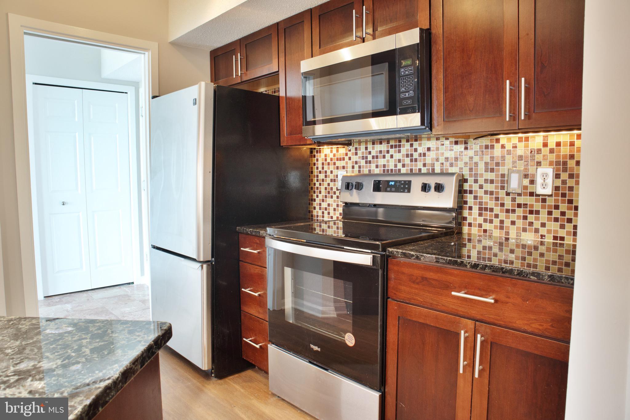 5505 Seminary Road, Unit 1210N Falls Church, VA 22041 - Photo 16 of 38 a kitchen with stainless steel appliances granite countertop a refrigerator stove and microwave