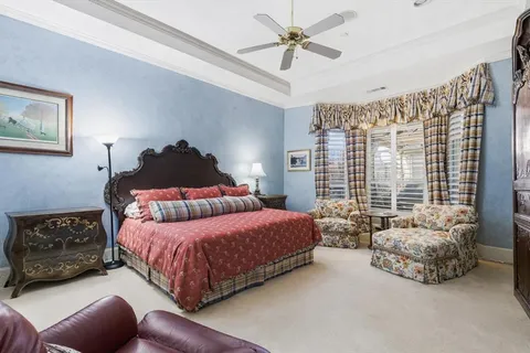 a bedroom with a bed a couch and a window