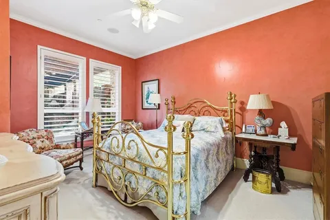 a bedroom with three beds and a chandelier