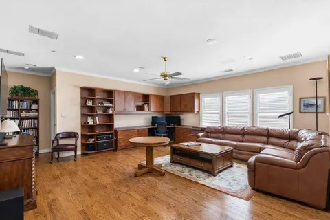 a living room with furniture and a wooden floor